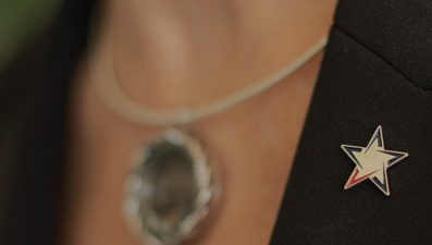 Vantage Bank lapel pin on bankers overcoat